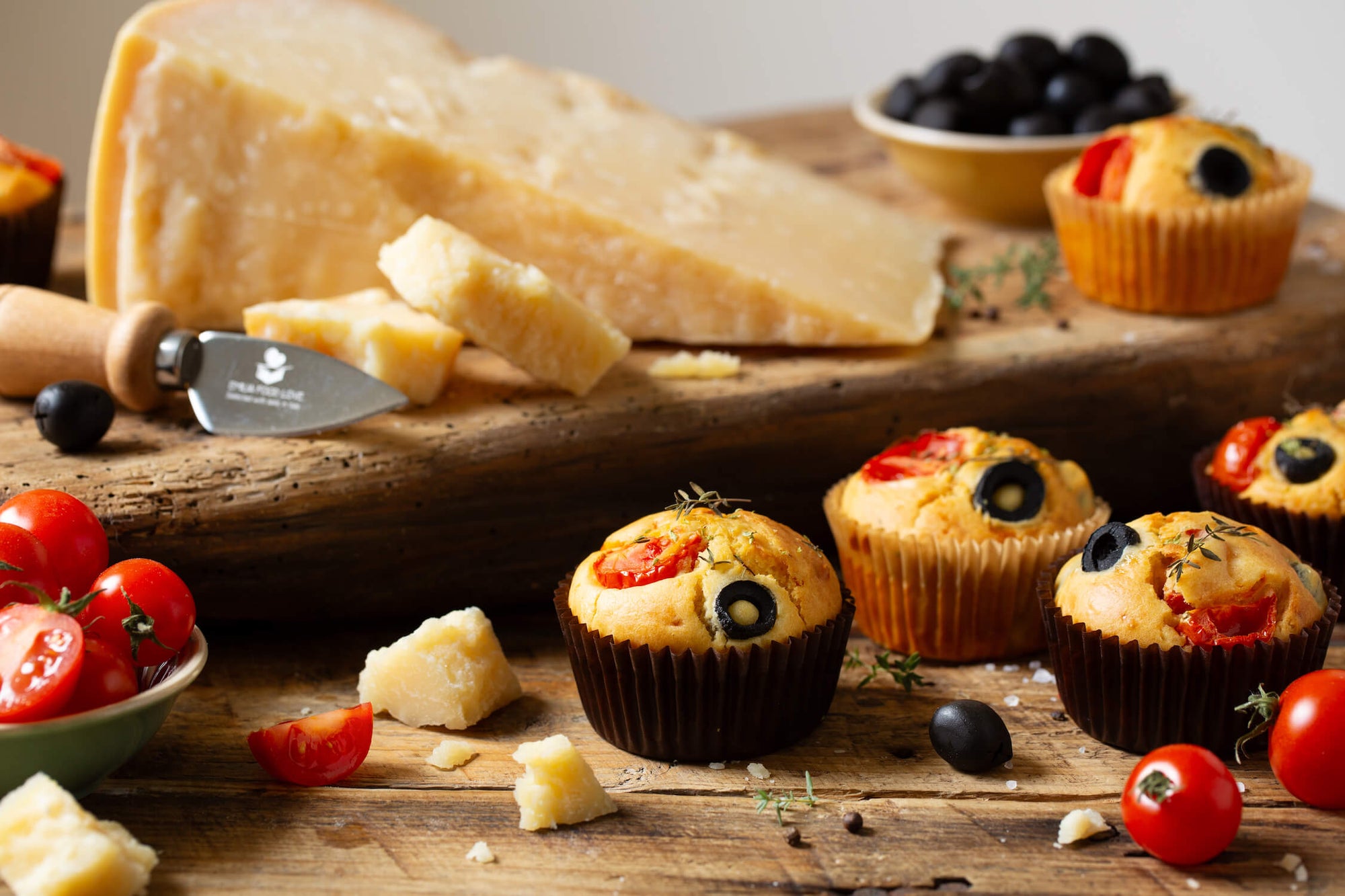 Savory Parmigiano Reggiano muffins with olives and cherry tomatoes